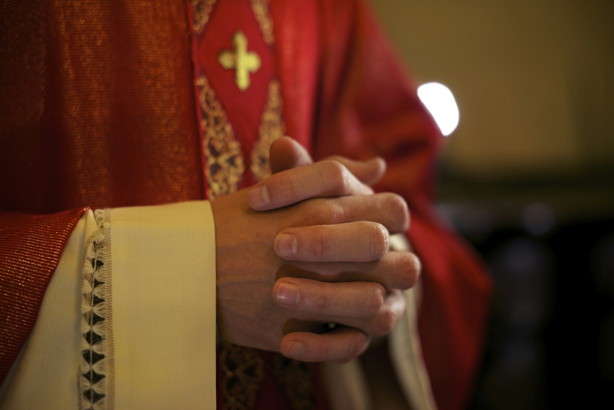 Catholic Priest On Altar Praying During Mass